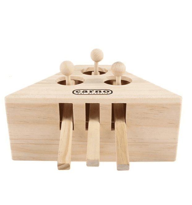 Cat playing with wooden activity puzzle board
